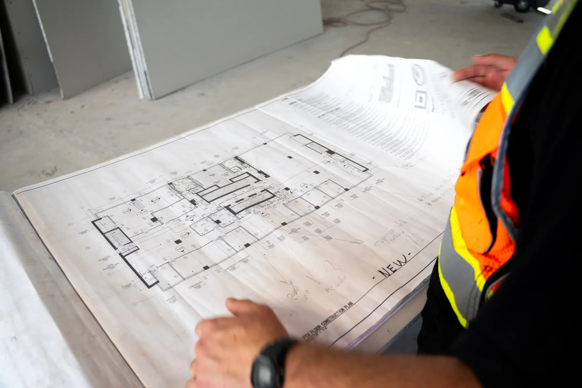 A JZ team member reviewing drawings at 100 Biscayne