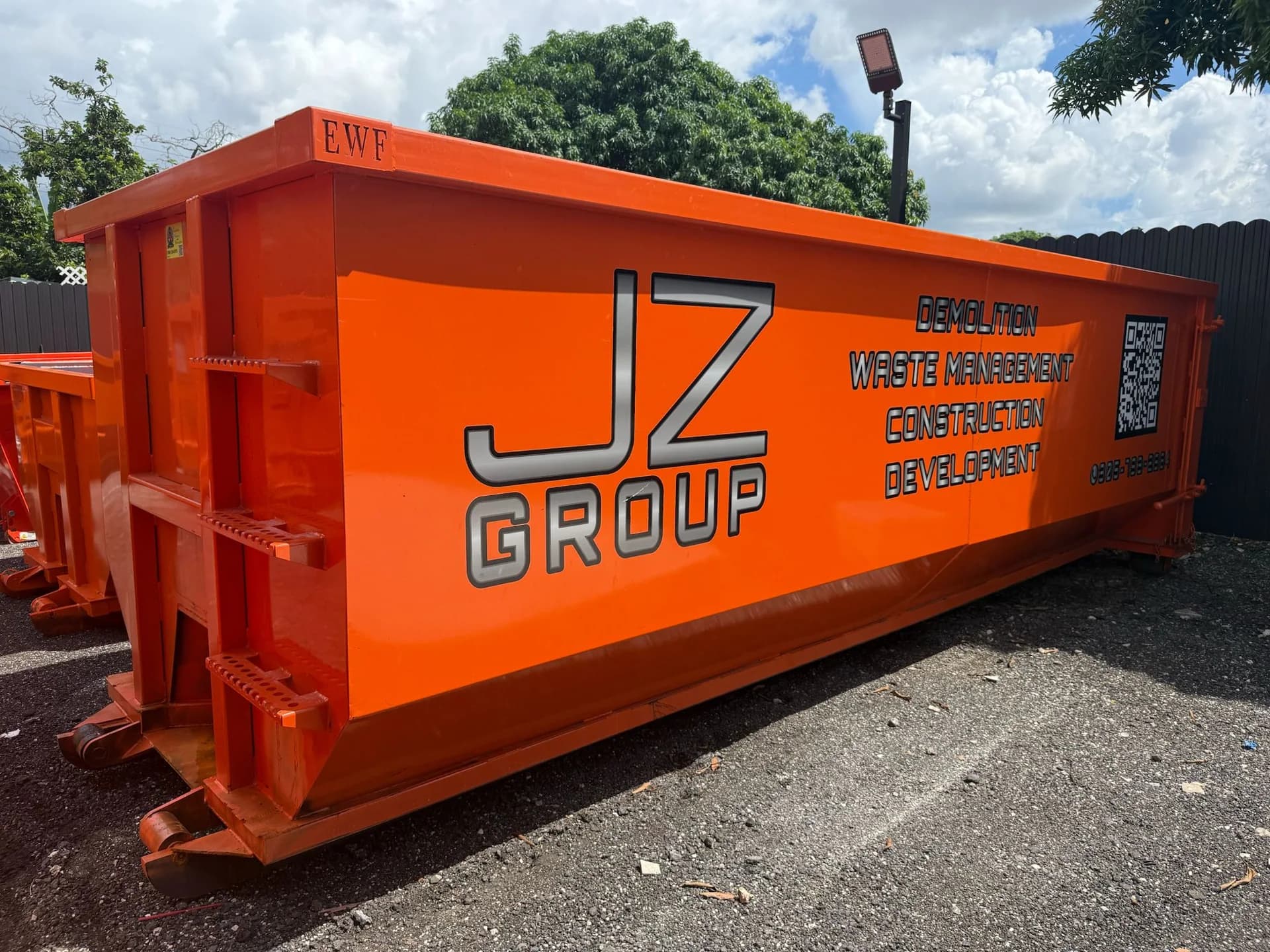 JZ-branded roll-off container in the equipment yard