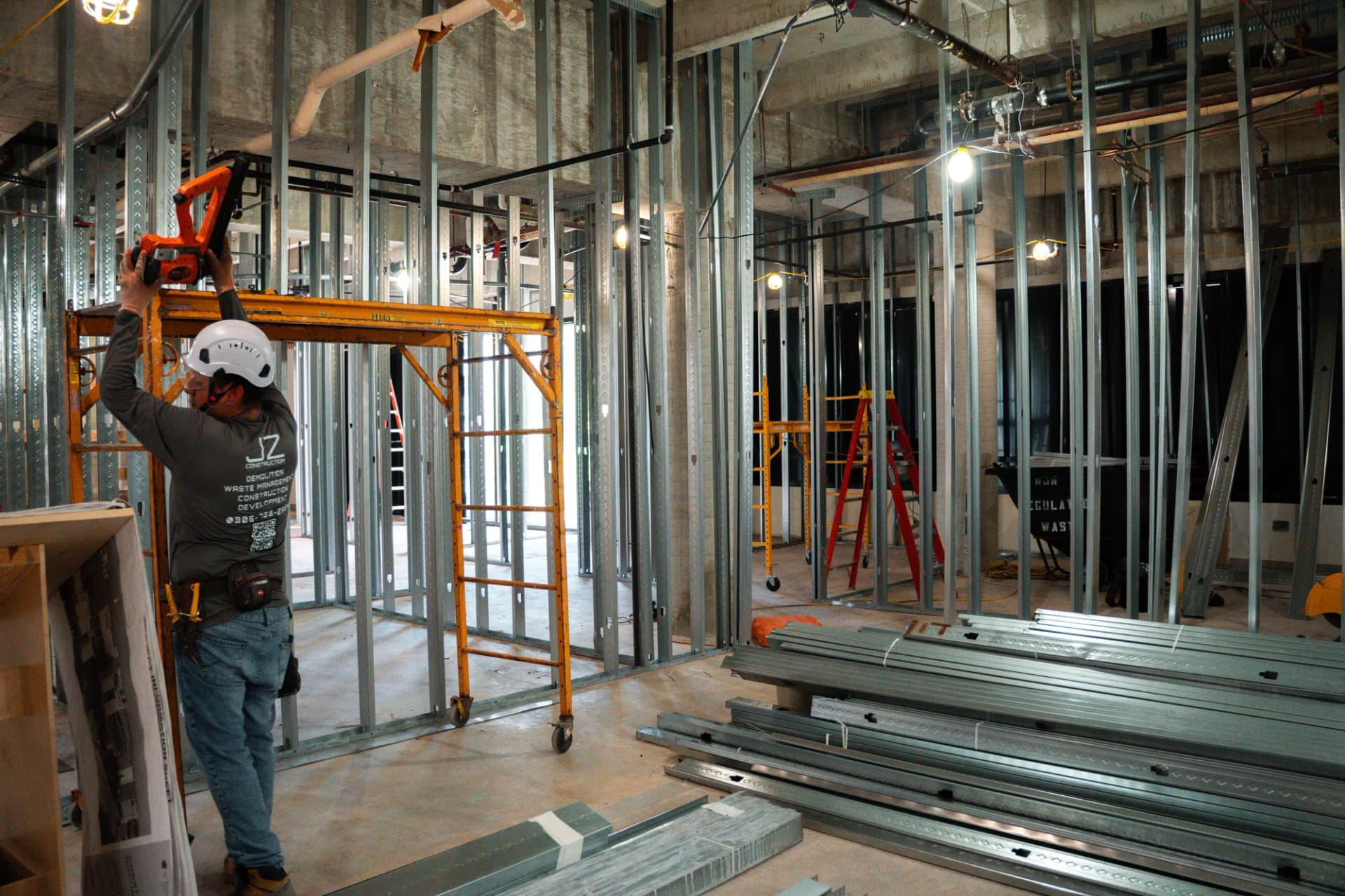JZ crew member beside a scaffold and metal framing materials at Bascom Palmer